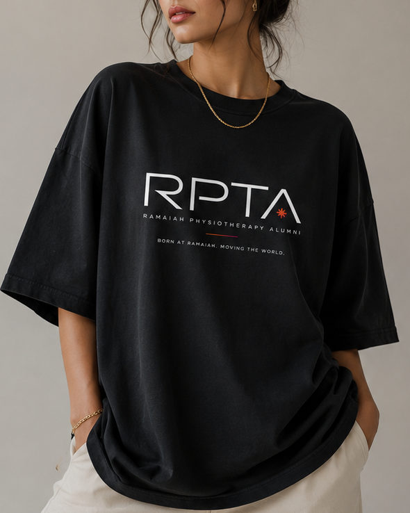 Oversized black RPTA tee worn front-on, with the RPTA wordmark, the asterisk mark and the line born at Ramaiah, moving the world printed across the chest.